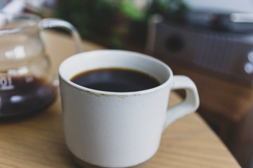 White cup of coffee on wooden table
