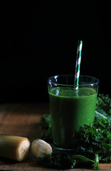 Kale smoothie with banana on black background