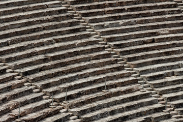 Stairs of the ancient theatre of Epidaurus in the Epidaurus town, on Peloponnesus peninsula, Greece. The theater was dedicated to the ancient Greek God of medicine, Asclepius. Stairs closeup.