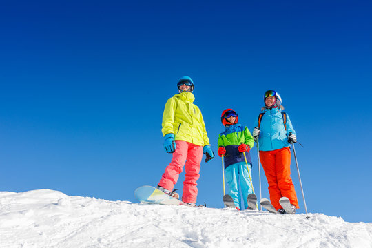 Happy family enjoying winter vacations in mountains . Ski, Sun, Snow and fun.