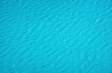 Aerial view at the water surface. Turquoise sea as a background. Waves on the sea. Waves as a background. Water-image