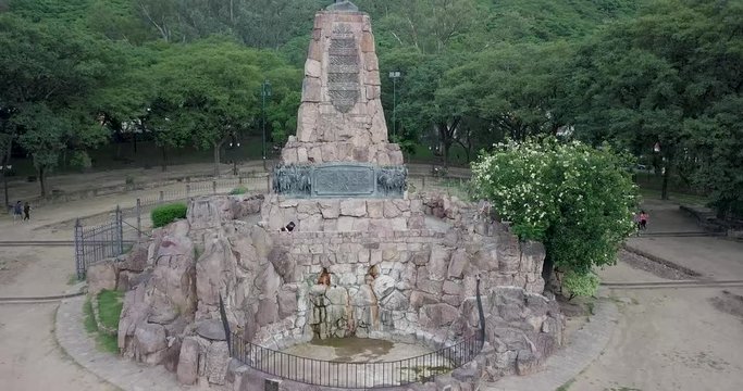 Ascending view of General Martin Miguel de Guemes monument surrounded by lush green hillside environment.