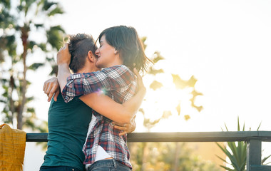 Happy gay couple embracing during sunset in park outdoor - Young lesbian women having a tender romantic moment outdoor - Lgbt, homosexuality love and lifestyle relationship concept