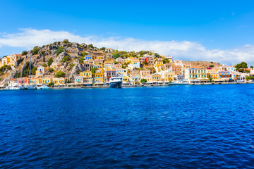 Colorful neoclassical houses in harbor town of Symi (Symi Island, Greece)