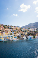 Fototapeta na wymiar Colorful neoclassical houses in harbor town of Symi (Symi Island, Greece)