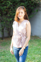 Fototapeta premium Beautiful portrait young asian woman standing and smile with sunlight at morning, girl looking camera with happy, female wear casual with cheerful, lifestyle and relax concept.