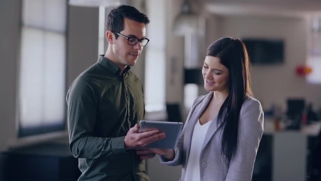 portait of two colleagues working on an technology using technology to solve problems