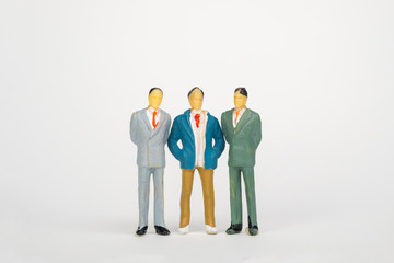 Group of figure miniature businessman or small people investor and office worker secretary on white background for money and financial business teamwork concept.