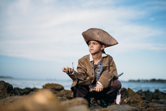 Little boy playing dress up like a pirate