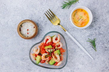salad with avocado, grapefruit and shrimps in bowl
