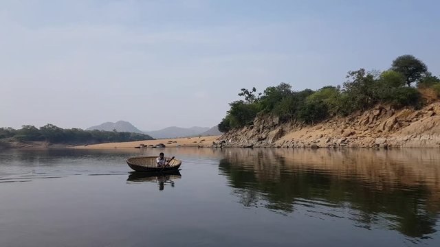A man crossing the Cauvery river on a coracle in Hogenakkal, Tamilnadu, India