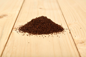 Ground coffee isolated on a wooden table