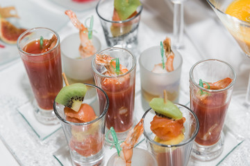 canapes with fruit and shrimps in glasses