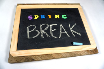 Fototapeta premium Spring Break message on chalkboard with colorful letters