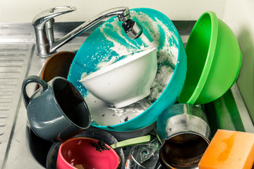 dirty dishes, cups, plates, spoons in the sink