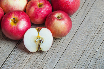 Fresh organic ripe red apples with water drops on wooden background, Apple fruit concept