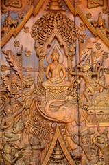 The wooden door is carved into buddhist history.