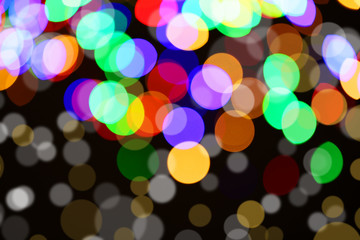 Shiny beautiful colorful lights on dark background. Bokeh effect