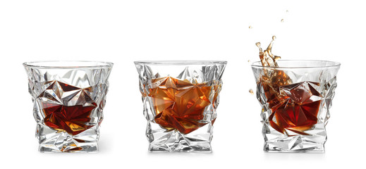 Set of glasses with expensive whiskey on white background