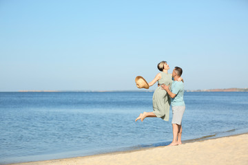 Obraz na płótnie Canvas Happy mature couple at beach on sunny day