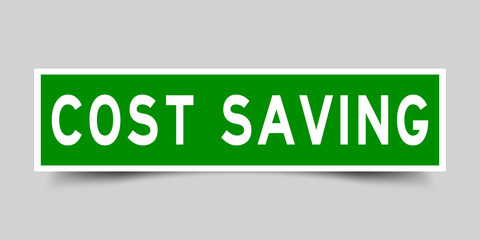 Square green color sticker with word cost saving on gray background