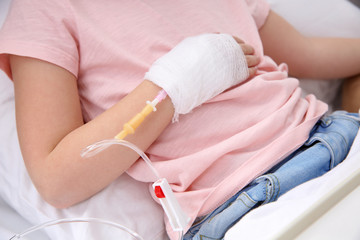 Little child with intravenous drip in hospital bed, closeup