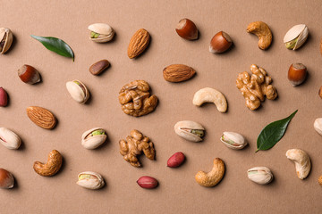 Flat lay composition with organic mixed nuts on color background