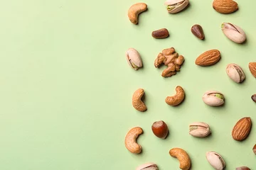 Fotobehang Flat lay composition with organic mixed nuts and space for text on color background © New Africa