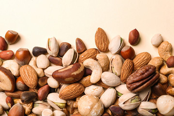 Flat lay composition with organic mixed nuts on color background