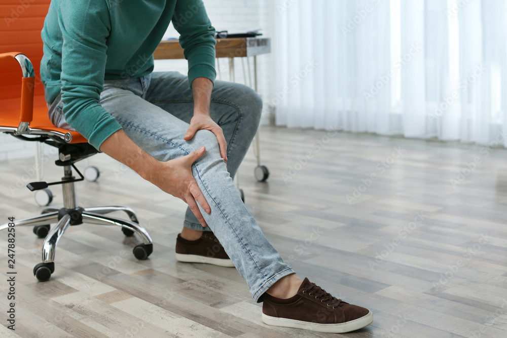 Canvas Prints Man suffering from leg pain indoors, closeup with space for text