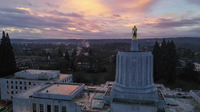 Dawn Sun Shines Through Clouds at The State Capital Building in Salem