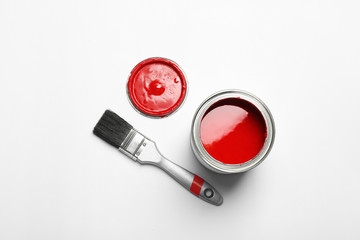 Paint can and brush on white background, top view