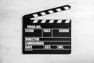 Obraz premium Clapperboard on wooden background, top view. Cinema production