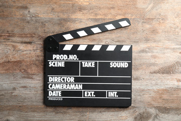 Obraz premium Clapperboard on wooden background, top view. Cinema production