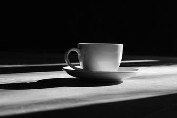 Coffee in white cup on the floor in the morning . 