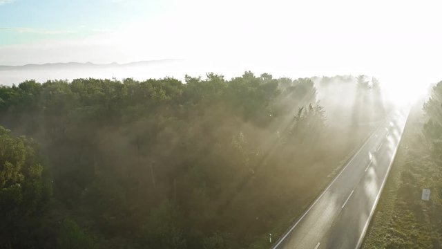 Beautiful detail of a road in a misty scenery at sunrise. Zadar Croatia. Aerial view travelling tilt up