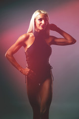 Fototapeta na wymiar Silueta Young Muscular Sports Woman on Black Background