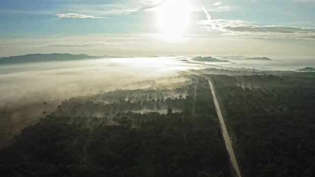 Beautiful misty landscape and a road at sunrise. Zadar Croatia. Aerial view travelling