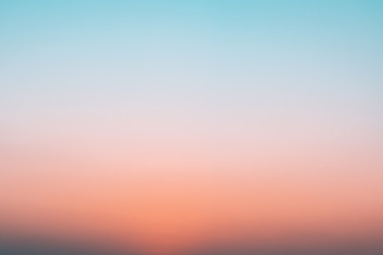 Abstract gradient sunrise in the sky with blue and orange natural background.