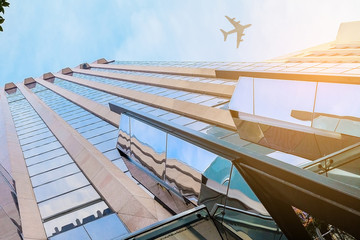 Obraz na płótnie Canvas Airplane above business city