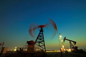 Crank balanced beam pumping unit in Jidong oilfield sunset scenery, closeup of photo