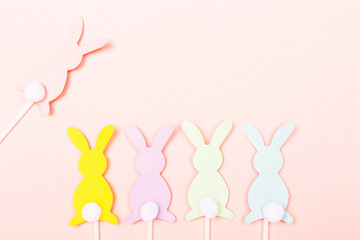 Easter bunnies on pastel pink background