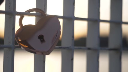 Close up of a heart padlock placed on a bridge in Amsterdam. Flat plane blurred effects - Powered by Adobe