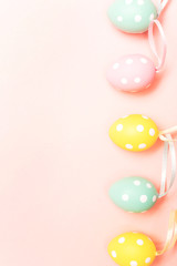 Easter eggs on pastel pink background