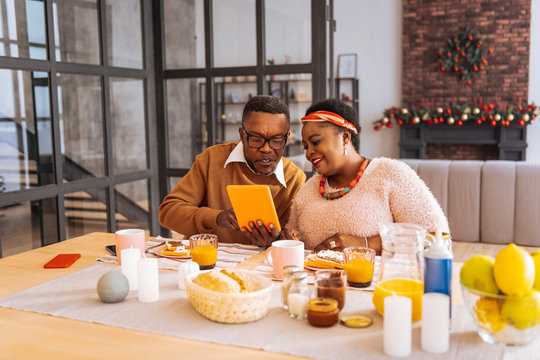 Positive joyful woman sitting together with her brother