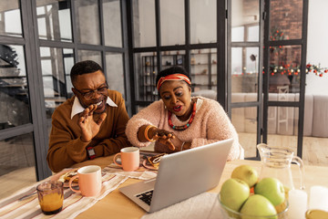 Happy positive brother and sister speaking to their family