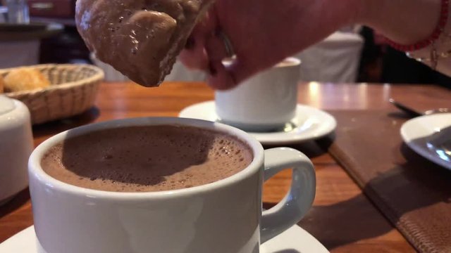 Mexican Concha Bread Into A Hot Cup Of Chocolate