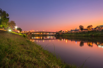 Beautiful White grass grass view the Nan River and the bridge (Eka Thot Sa Root Bridge) at sunset in Phitsanulok City, Thailand.