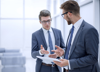 two colleagues looking at the digital tablet screen