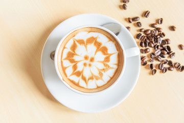 Top view of hot cappuccino with nice milk pattern on white background / top view of hot cappuccino